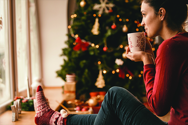 girl-sitting-in-front-of-holiday-tree