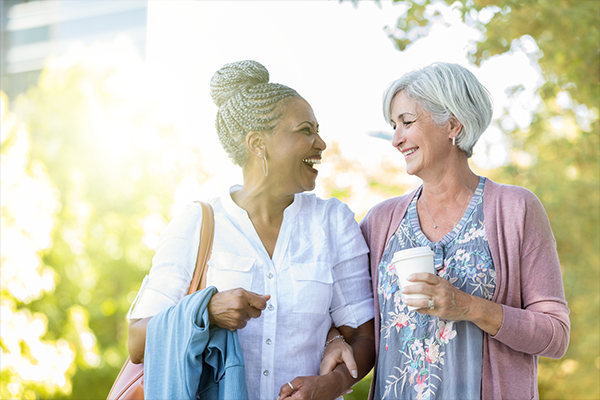 two-women-walking-and-laughing