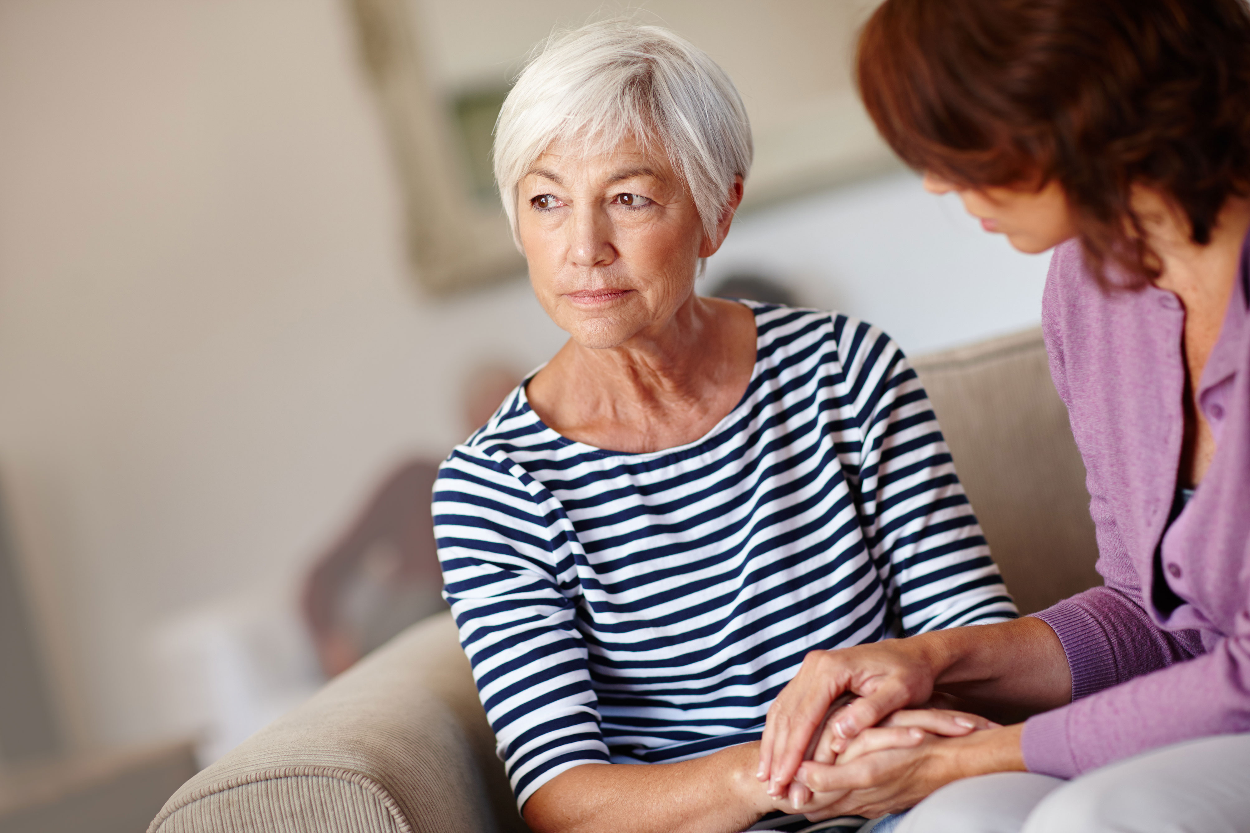 older woman sitting sad 