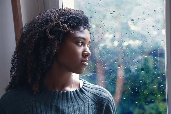 woman unhappy rainy window