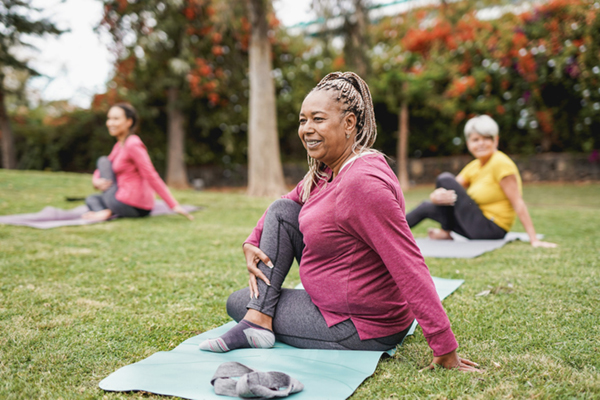 people doing yoga in park